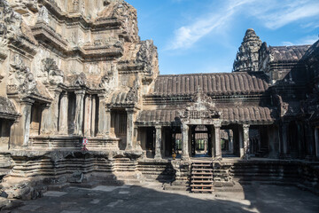 Angkor Wat, A remarkably tall building set against a clear blue sky backdrop
