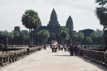 Angkor Wat, A remarkably tall building set against a clear blue sky backdrop