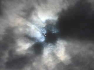 The passing of dark clouds, reveals a solar eclipse. Visible in the skies above Kent County, Delaware, April 8, 2024.