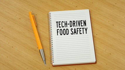 Tech-driven food safety text message on note pad. Wooden background and pen 3d render