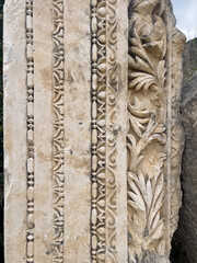 Ancient Roman Decorative Stone Column Fragment With Floral Carvings, Located Outdoors In Turkey, Daytime Light, Ideal For Cultural Heritage, Tourism, History, Art, And Architecture Projects
