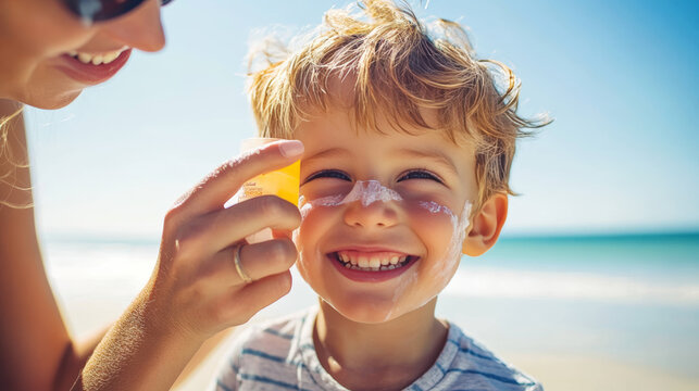 A Caucasian motherâ€™s hand applies sunscreen from a plastic container to her smiling son before sun exposure during a summer beach vacation. Close-up with copy space - Powered by Adobe