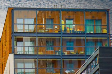 The facade of a modern residential building in the city represents key aspects of the real estate...
