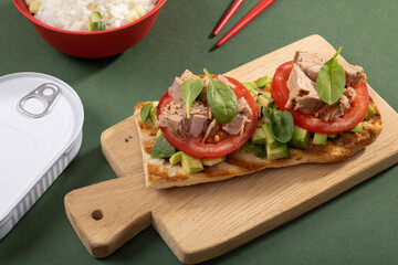 Tuna sandwiches on a table next to lemonade and beer, in a modern interior design