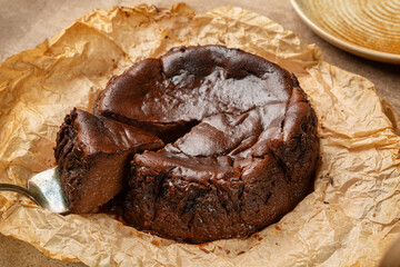 Fototapeta premium Slice of Chocolate Basque Burnt Cheesecake, homemade version of famous San Sebastian dessert.