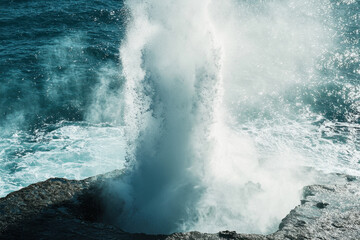 Obraz premium A blowhole is a coastal geological formation where seawater forcefully erupts through a natural vent due to wave pressure