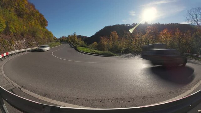 Cars traffic timelapse on an S-shaped mountain road in the Schw&auml;bische Alb National Park in autumn settings
