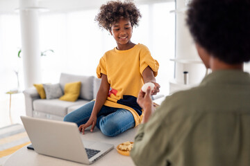 Joyful African Mother and Daughter Cooking Together in Bright Modern Kitchen