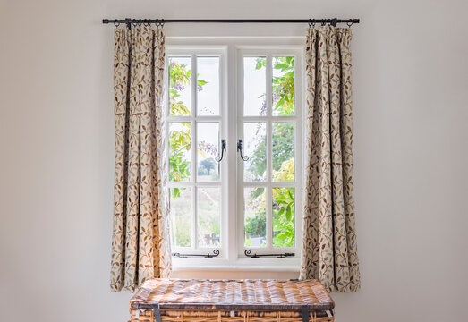 Traditional window with curtains in a UK period home interior