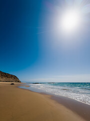 Sandy beach and blue sky on a bright sunny day