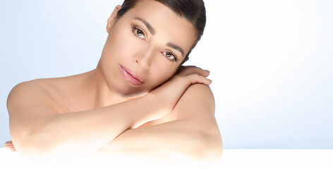 Gorgeous natural woman with flawless skin, showcasing beauty and skincare concept, isolated on a light background with copy space, gentle pose highlighting healthy skin and serene expression