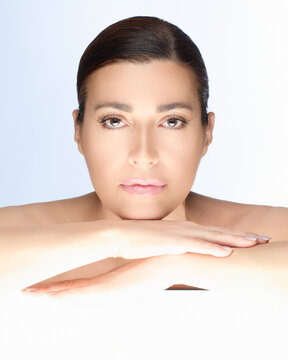 Gorgeous natural woman with flawless skin, showcasing beauty and skincare concept on a bright background