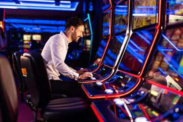 Man Enjoying Slot Machines in Vibrant Casino Setting