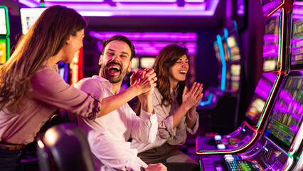 Friends Celebrating a Win at the Casino Slot Machines Vibrant Setting