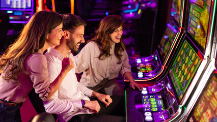 Friends Enjoying Slot Machine Games in a Vibrant Casino Setting
