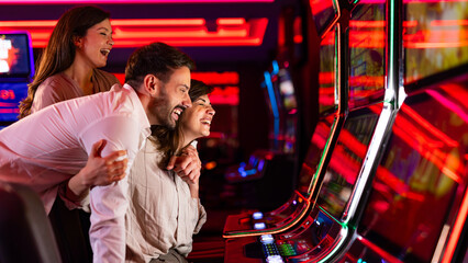 Fototapeta premium Friends Enjoying a Fun Evening in a Vibrant Casino Environment