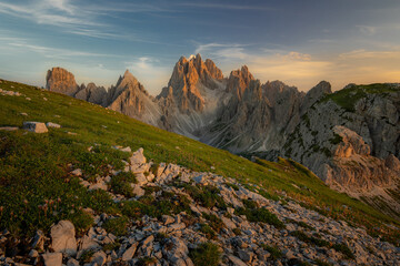 Cadini di Misurina mountain ridge. Beautiful sunset with clouds in Dolomites mountains. Epic mountain, colorful flowers, rocks, forest. Premium landscape from pure nature, Dolomiti, Alps, Italy