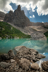 Lago di Sorapis, lake Sorapis. Beautiful sunset with clouds in Dolomites mountains. Epic blue lake, mountain, cliffs, rocks, forest. Premium landscape from pure nature, Dolomiti, Alps, Italy