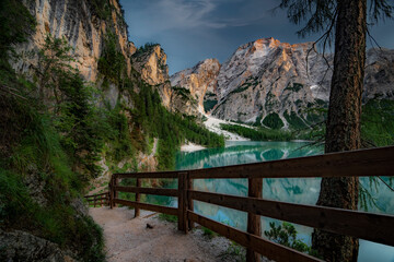 Lago di Braies, Pragser Wildsee. Beautiful sunset with clouds in Dolomites mountains. Epic blue lake, mountain, cliffs, rocks, forest. Premium landscape from pure nature, Dolomiti, Alps, Italy