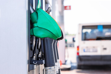 Close up of gas station Nozzles. Refueling pistols on  a pistole holder.  Vehicle gasoline refill...