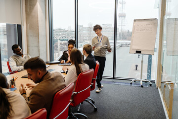 A White young man with glasses, a multinational group of people collaborating in an internship...