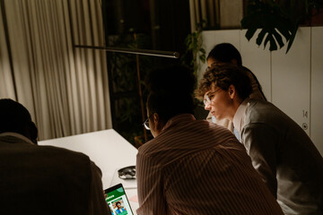 A multinational group of interns and mentors are working together and collaborating and discussing...