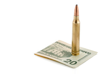 Military cartridge lies on the background of US dollars. Full depth of field.