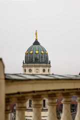 Obraz premium Closeup of the New German Cathedral Dome. Iconic Berlin landmark with golden statue details, seen from the French Church rooftop terrace against a soft skyline. Minimalist photo. Copy space