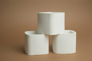 white plaster vessels blanks for candlesticks. rectangular cups cast from plaster in a candle workshop. High quality photo