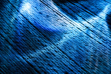 Blue light illuminating diagonal texture of rough stone surface