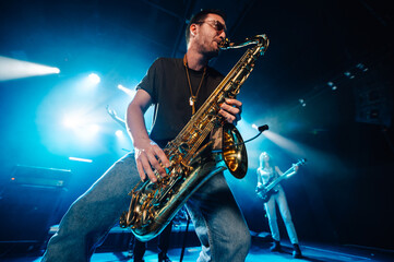 Saxophonist performing live on stage with passion and energy