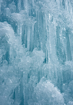 Cold winter icicles melting banner. Blue frozen ice close-up photograph. 	