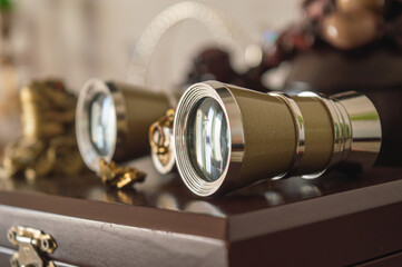 Theatrical retro binoculars with chrome parts lying on a polished box. High quality photo