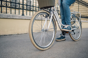 Obraz premium Student riding vintage bicycle in urban setting