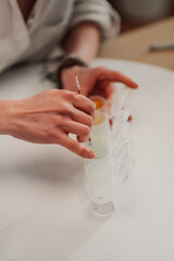 Artist dipping brush in watercolor tray getting ready to paint