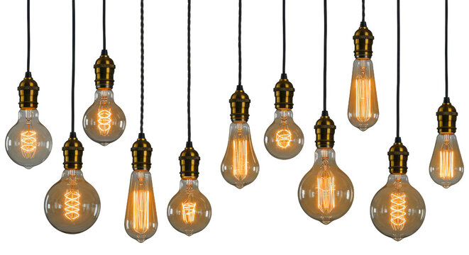 A collection of vintage edison light bulbs hanging against a dark black background in a studio setting