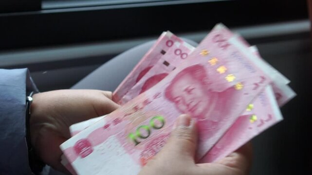 Chian yuan cash money one hundred Chinese yuan bills, yuan banknotes Chinese currency (Renminbi or RMB) featuring 100-yuan banknote with Mao Zedong's for goods services, Cash on car