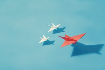 Origami planes on light blue background