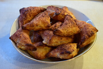 Golden-Brown Triangular Pastries Freshly Baked