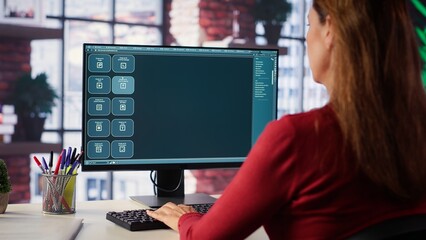 Focused woman working with an AI chatbot on her desktop computer, offering real time assistance and...