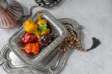 Multicoloured churchellas on a richly decorated silver dish in the interior of the Uraza-Baram...