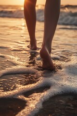 Naklejka premium Walking on wet beach at sunset with feet in water and surf foam from crashed waves.