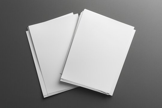Two blank white A4 papers on a grey background creating a clean and simple presentation.