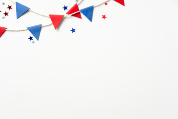 Colorful, patriotic party setup with red and blue flags and star confetti on a plain white background. Perfect for festive celebrations, holidays, or themed events