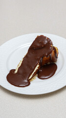 Close-up of a slice of New York-style cheesecake on a white plate.