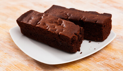 Fresh brownie on wooden background, sweet food