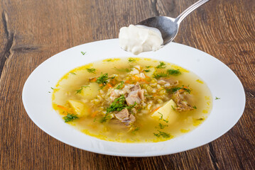 Add sour cream to freshly prepared Leningrad-style rassolnik soup.