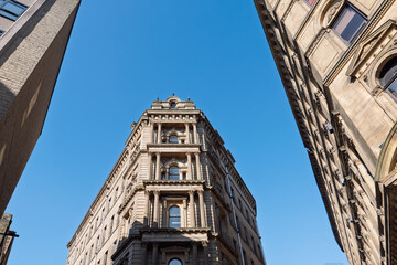 Corner view of tall 19th century neoclassical building in the Bradford Little Germany District