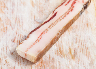 Appetizer salted pork bacon at wooden background, nobody