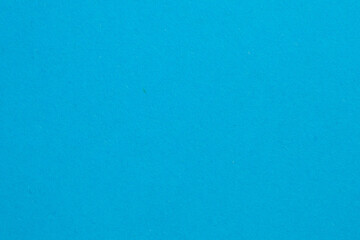 A blue background with a white dot in the middle, textured origami paper backdrop